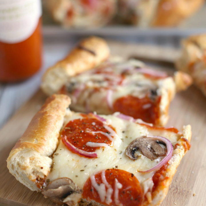 The BEST French Bread Pizza! Takes less than 30 mins to prepare. Click for the full recipe.