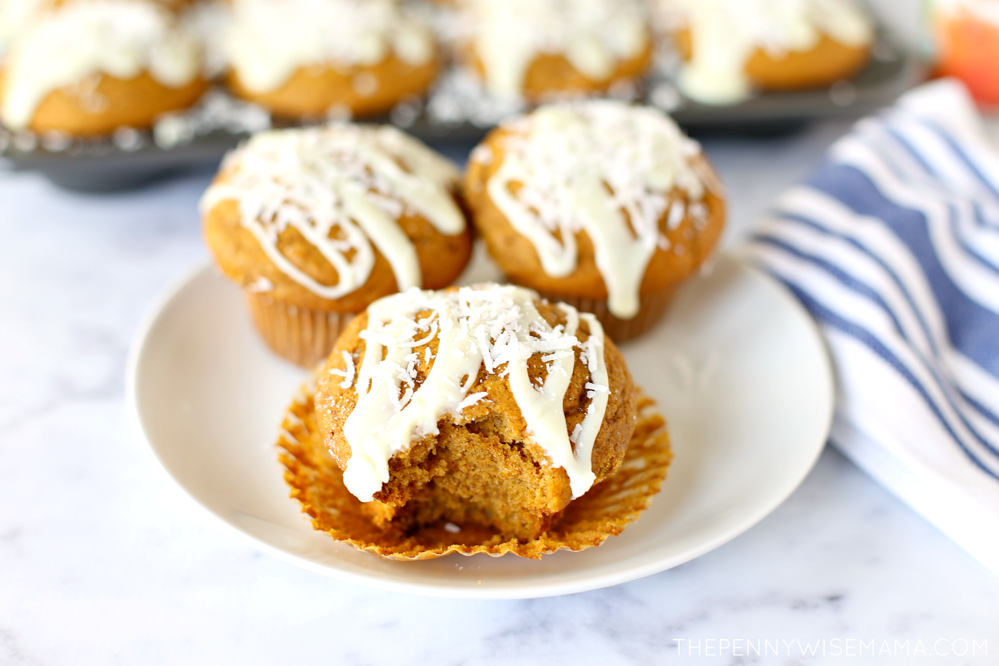 Delicious Pumpkin Muffins topped with white chocolate glaze and shredded coconut